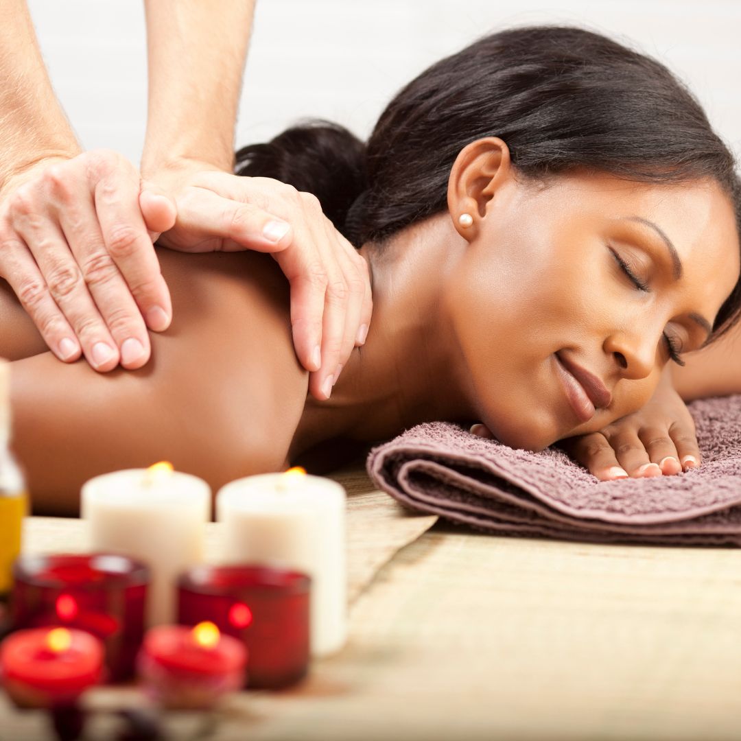 4BenefitsofMassageTherapy-image2 Woman looking peaceful while getting a massage.